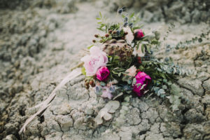 Bouquet of flowers lies on dry ground Bouquet of flowers lies on dry ground